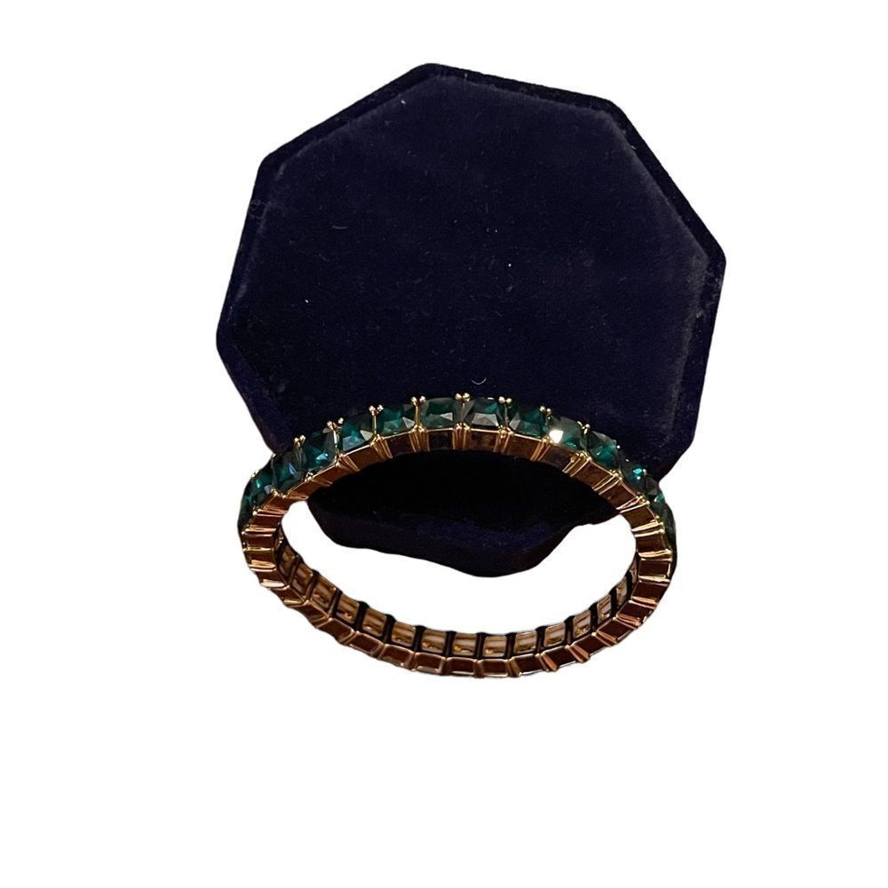 Stretchy gold tone bracelet with green square rhinestones